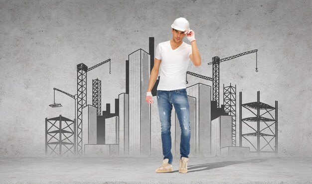 building, construction and renovation concept - handsome builder in helmet and gloves