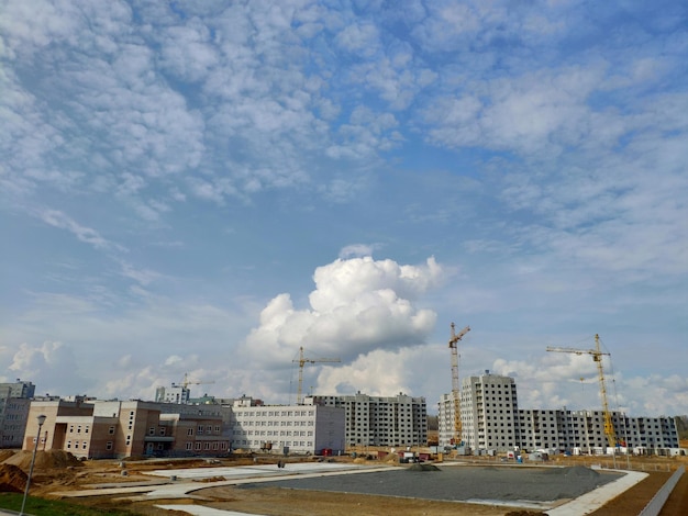 A building under construction with a blue sky and clouds