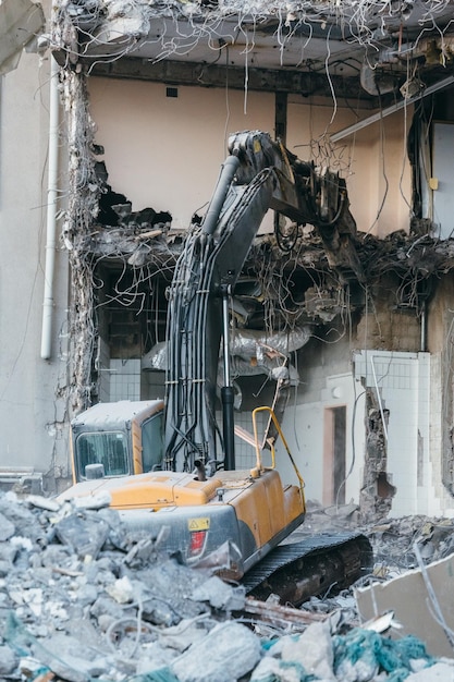 Building demolition excavator destruction of house ruins\
reconstruction hydraulic excavator