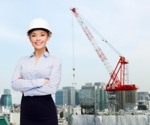 building, developing, construction and architecture concept - smiling businesswoman in white helmet