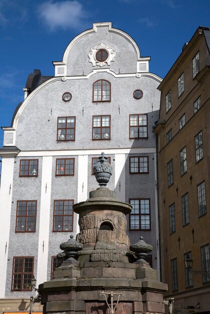 Building Facade and Fountain Stortorget Square in Gamla Stan, City Centre, Stockholm, Sweden