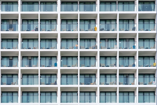 Building facade with balcony with table and chair. Hotel apartment balcony texture pattern.