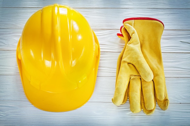 Building helmet leather protective gloves on white board