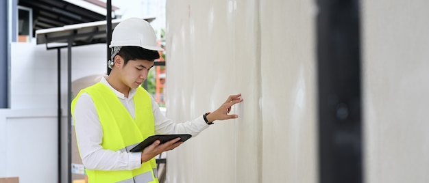 Building inspector architect man writing report and checklist in the home building