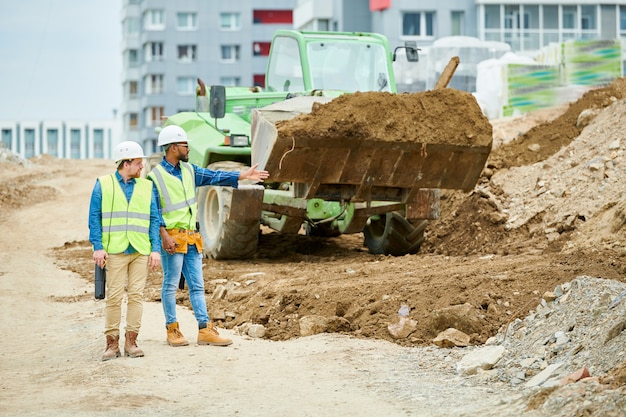 Building inspectors watching excavation process