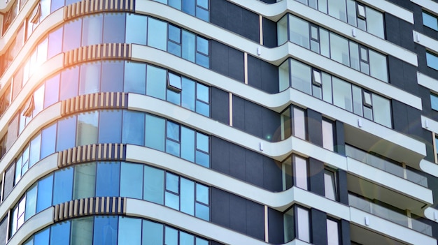 the building is made of glass and has a blue glass facade.