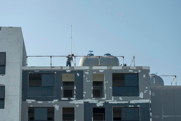 Building renovation and worker working on the building