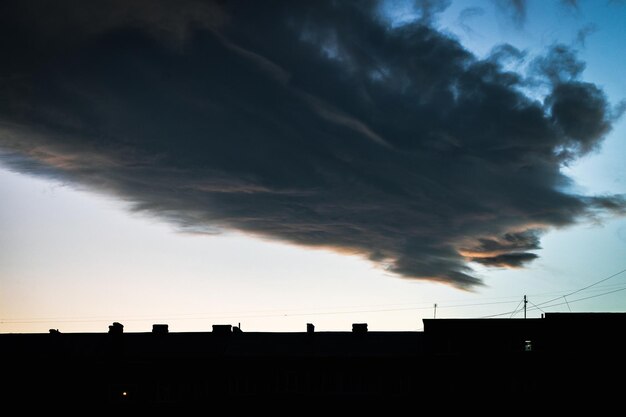 Building silhouette on sky clouds background