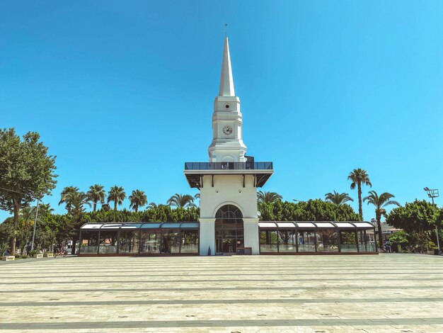 Building spire in a tropical hot country white high sharp spire on the roof a building with a tower