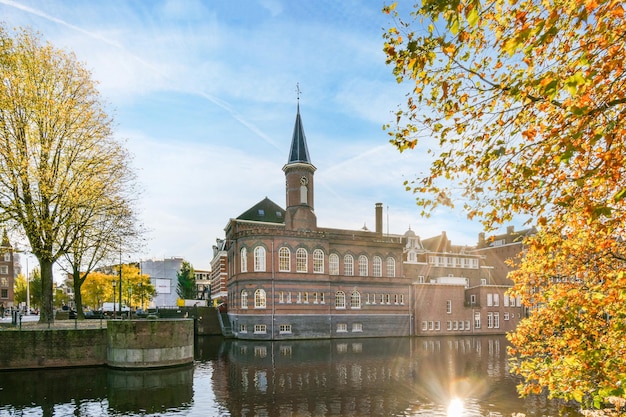 A building on the water in a city with trees