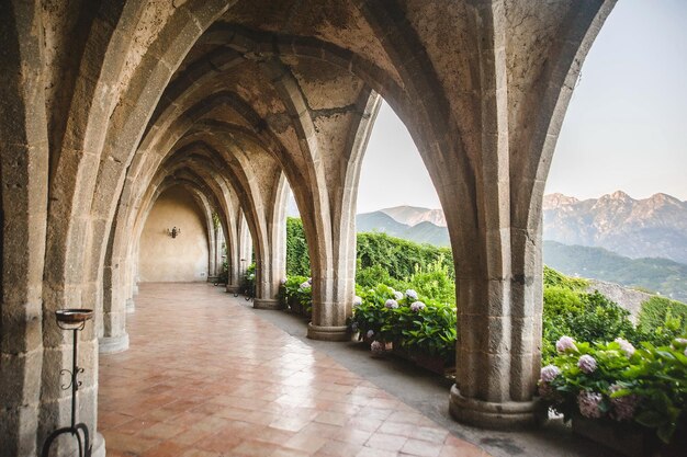 a building with an arched ceiling has a view of mountains and a mountain