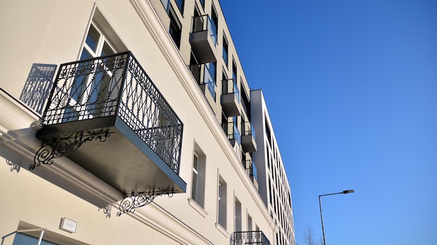 a building with balconies and a blue sky in the background