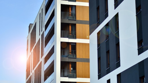 a building with a balcony that says " the sun " on the left.