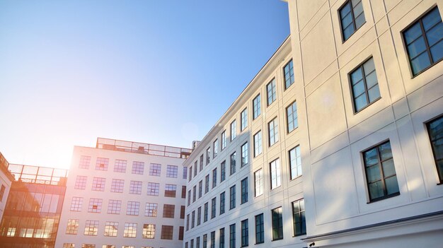 a building with a blue sky and a sun shining on it