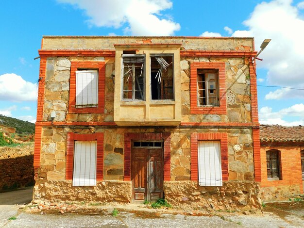 A building with a broken window and a sign that says " the word " on it.