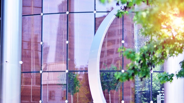 A building with a circular shape and a circle of trees in the background