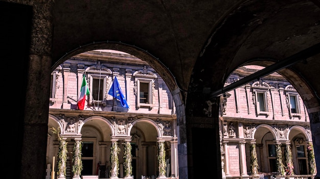 A building with flags on the top and a flag on the right