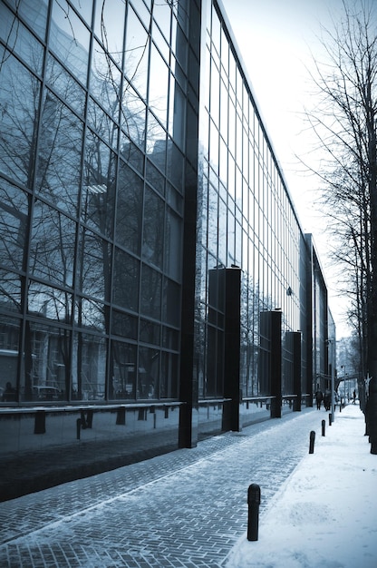 A building with a glass facade and a blue sky in the background.