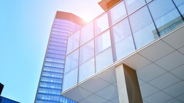 A building with a glass facade and a building with the sun shining through it