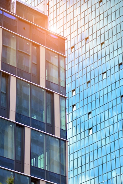 a building with a glass facade and the sun shining through it.