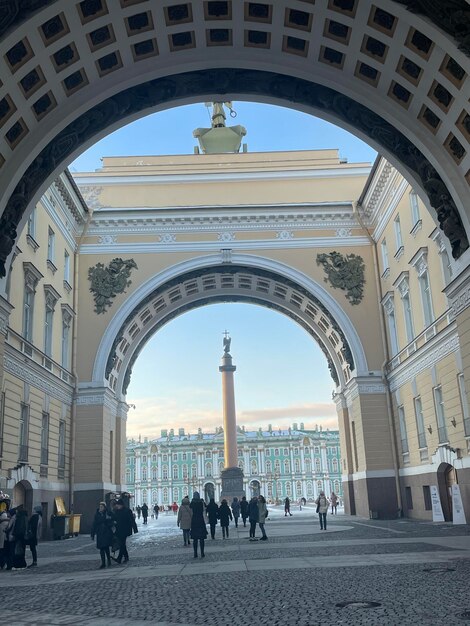 Foto un edificio con un grande arco e una statua della cattedrale di alexander nevsky sullo sfondo.