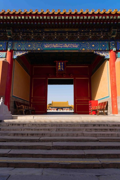 A building with a red door and a yellow roof