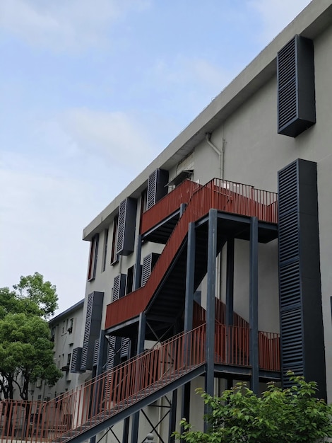 A building with a red staircase and blue sky