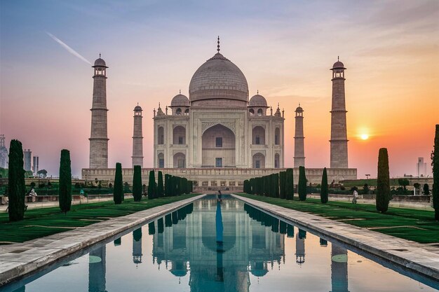 Photo a building with a reflection of a sunset in the water