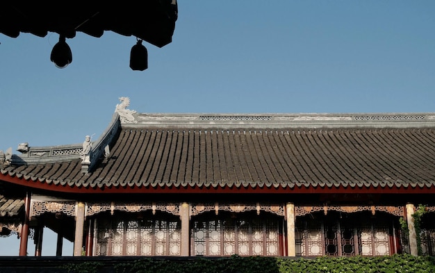 A building with a roof that has a chinese writing on it