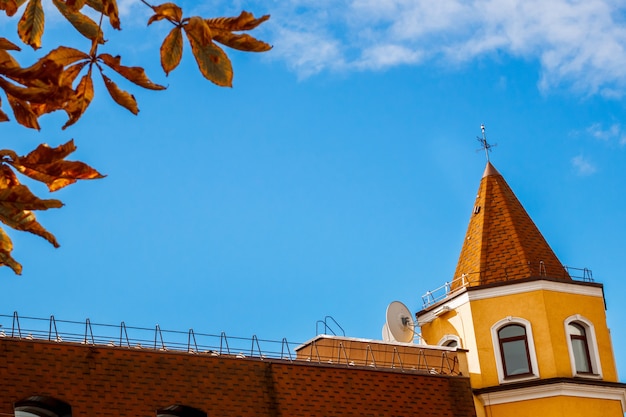 Building with a spire on a blue sky background.