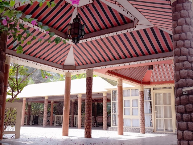 A building with a striped awning that has a pink and white striped awning.