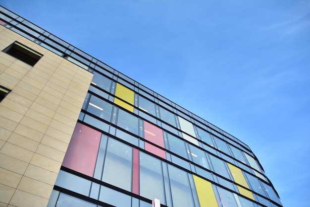 a building with a yellow and red and blue window frames.