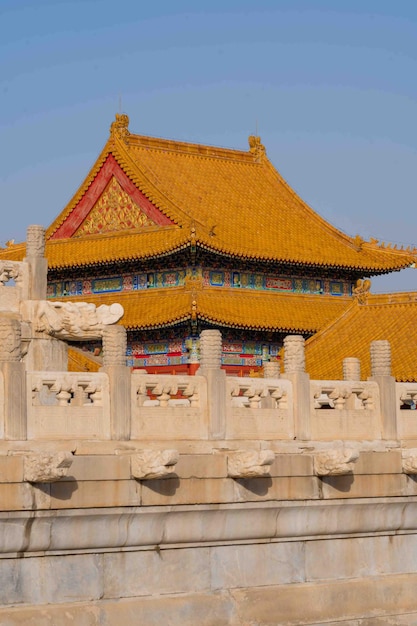 A building with a yellow roof and a dragon on the top.