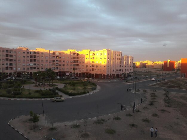 Buildings against cloudy sky at sunset