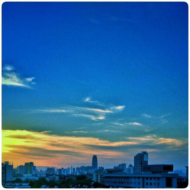 Buildings against cloudy sky