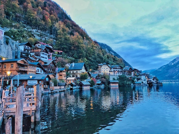 Buildings by lake against sky