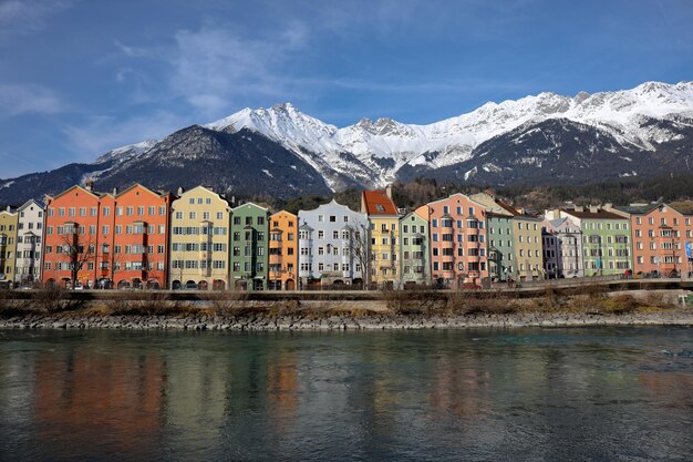 Buildings by mountains against sky during winter