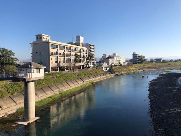 写真 澄んだ青い空に沿った川の建物