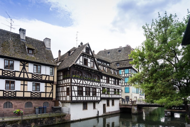 buildings by river against sky in city