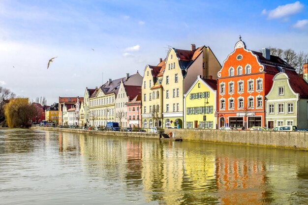 Buildings by river against sky in city