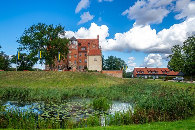 Buildings by river against sky