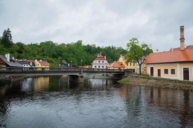 Buildings by river against sky