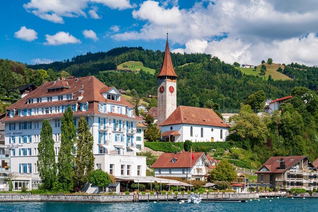 Buildings by river against sky