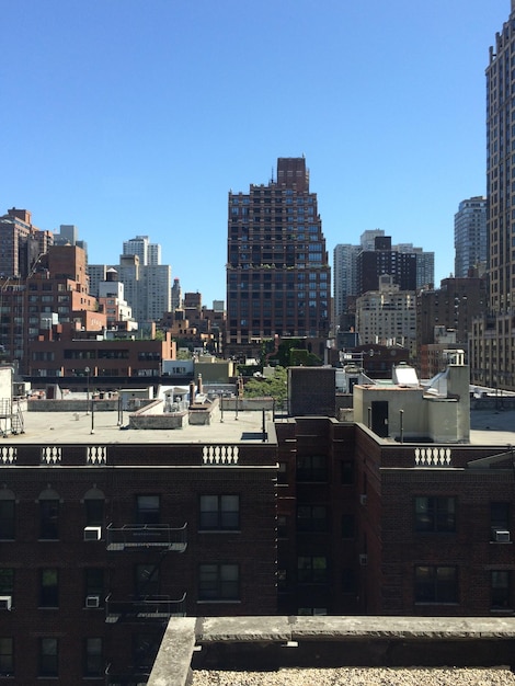 Buildings in city against blue sky