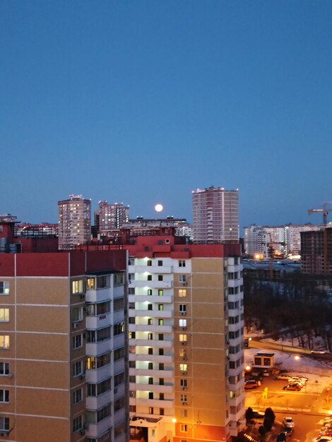 Buildings in city against blue sky