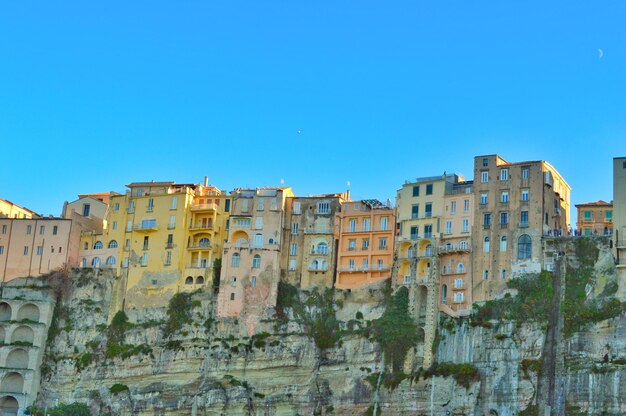 Buildings in city against clear blue sky