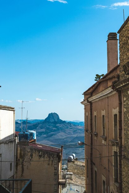 Buildings in city against clear blue sky