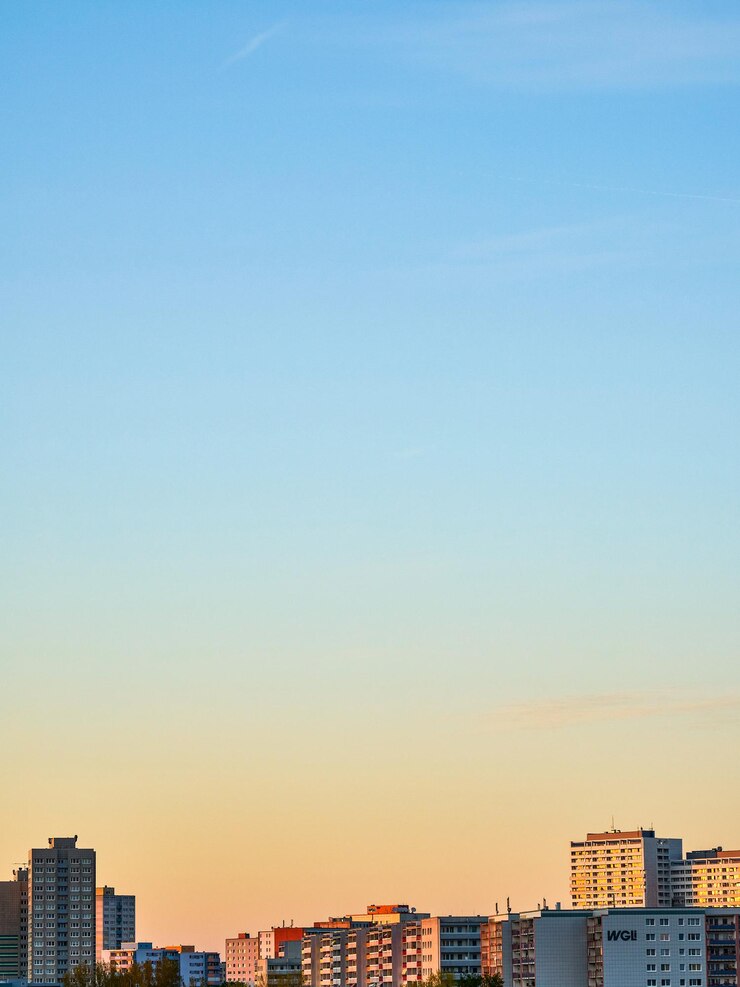 Photo buildings in city against clear sky during sunset