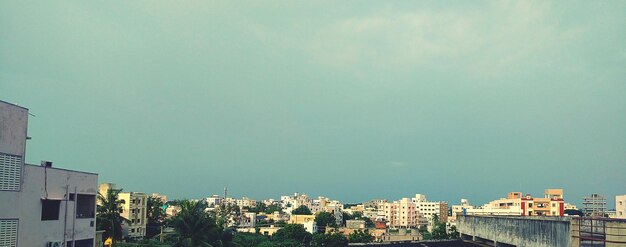 Buildings in city against clear sky