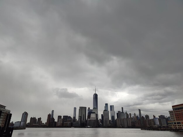 Buildings in city against cloudy sky